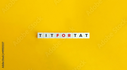 Tit for Tat English Saying on Letter Tiles on Yellow Background. Minimal Aesthetics.