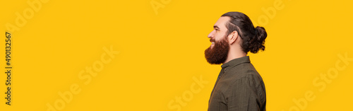 Panorama photo and side portrait of a bearded man over yellow background.