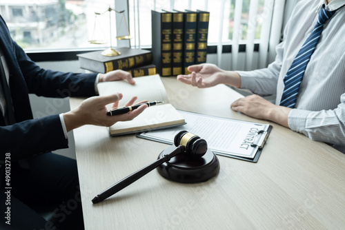 фотографія Male lawyer working on documents contract papers of the important case with the