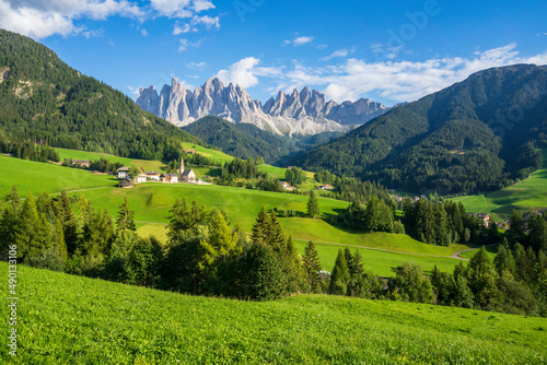 Green grassy meadows in the village of Santa Maddalena against the great peaks of the Odle Group  Val di Funes  Dolomites.