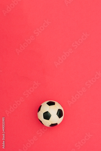 Football and soccer mock up blank template design idea. Black and white soccer ball mockup against pastel pink background. Copy space templates designs for message layout.