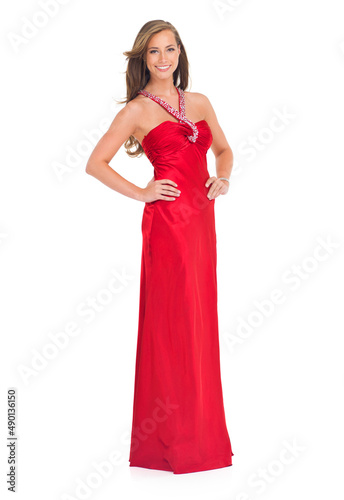 Such beauty and elegance. Studio shot of a stylish young woman in a red dress isolated on white.