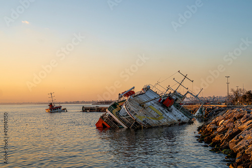 Abandoned  boat with beautiful sunset .Shipwrecked boat in Turkey