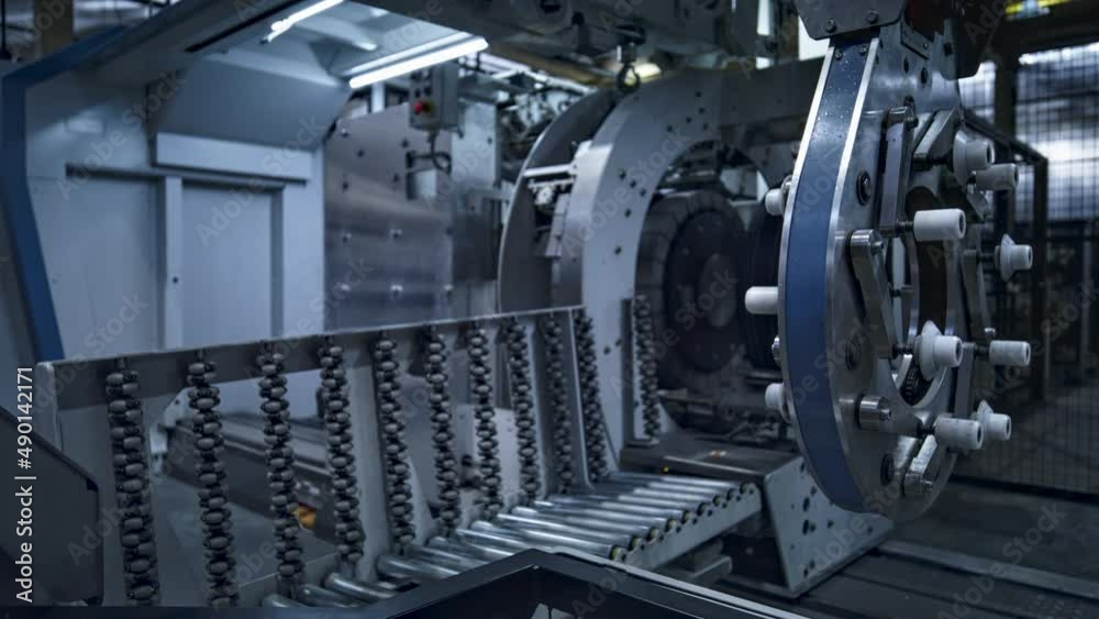 Tire factory employee working with modern industrial machine taking production Tire factory employee working with modern industrial machine taking production
