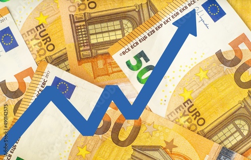 Obraz na płótnie the euro is rising: euro exchange rate increase illustration with blue arrow on money background w salonie