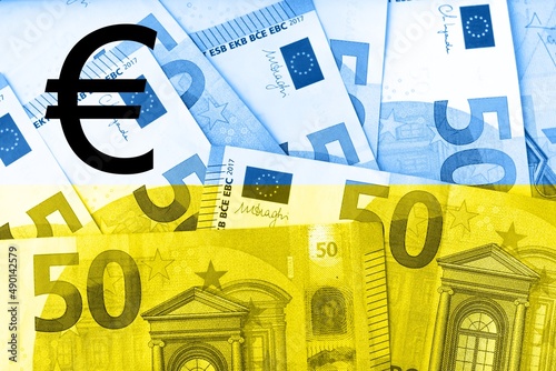 Obraz na płótnie Euro sign on blue and yellow background made of euro cash banknotes. 3D rendering illustration for financial and economic topics. w salonie