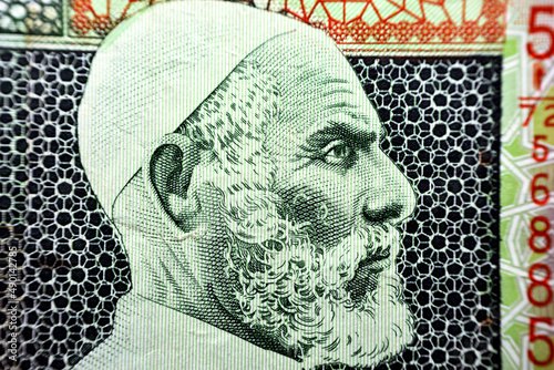 Portrait of Omar Al-Mukhtar (1861 - 1931), Portrait from the obverse side of Libyan ten 10 Dinars Banknote. An Old paper Libyan money banknote, vintage retro. Famous ancient Banknote. Collection. photo