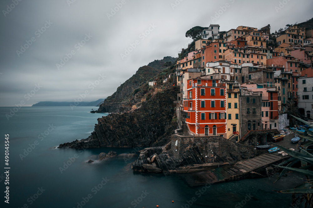 seascape with the town of riomaggiore on a rainy day
