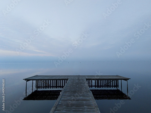Wooden pontoon on a foggy lake