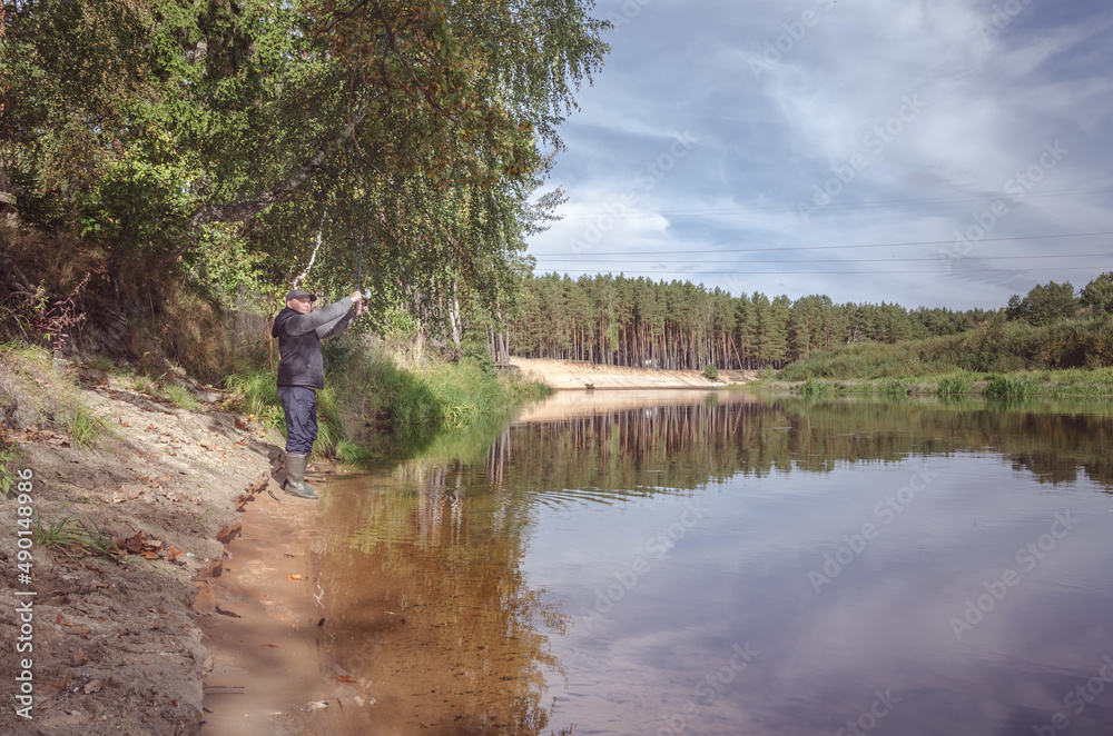 Fisherman on the bank of a beautiful river. Fisherman on the bank of a beautiful river.