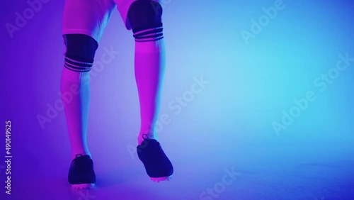 keepie uppie skill of talented football player, closeup of feet in football boots and ball in studio photo