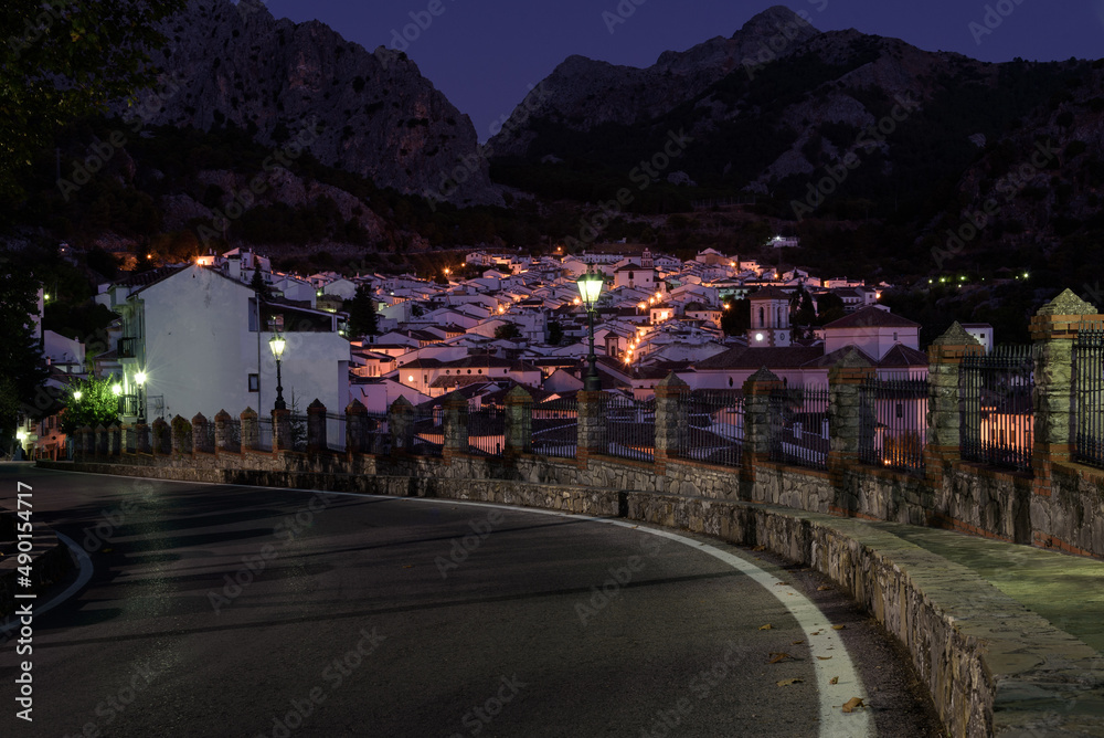 Panoramic view of the beautiful andalusian illuminated white town of Grazalema in Grazalema mountain range at sunrise, Cadiz, Andalusia, Spain