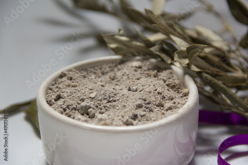 Fotografija bowl with ashes and olive branch. ash wednesday concept