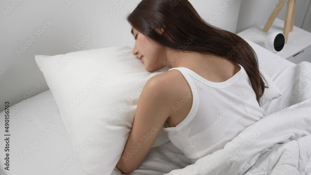 Young beautiful woman sleeping in her bed and relaxing in the morning Young beautiful woman sleeping in her bed and relaxing in the morning