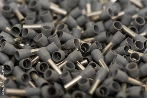 Electric wire ferrules or end sleeves for electrical cables as background. Crimp terminals for electrical wires, tools for electricians 