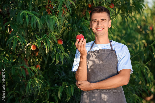 Young man with sweet peach ...