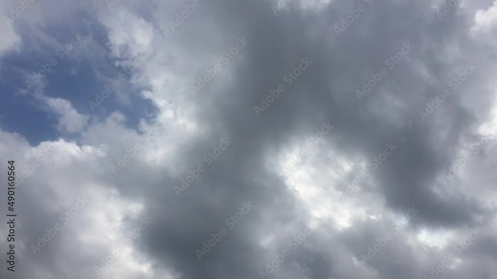 Layered clouds quickly run across the sky. Summer sunny day, white cumulus and cirrus clouds quickly fly across the sky. They change their shape and size on the fly. Layered clouds quickly run across the sky. Summer sunny day, white cumulus and cirrus clouds quickly fly across the sky. They change their shape and size on the fly.