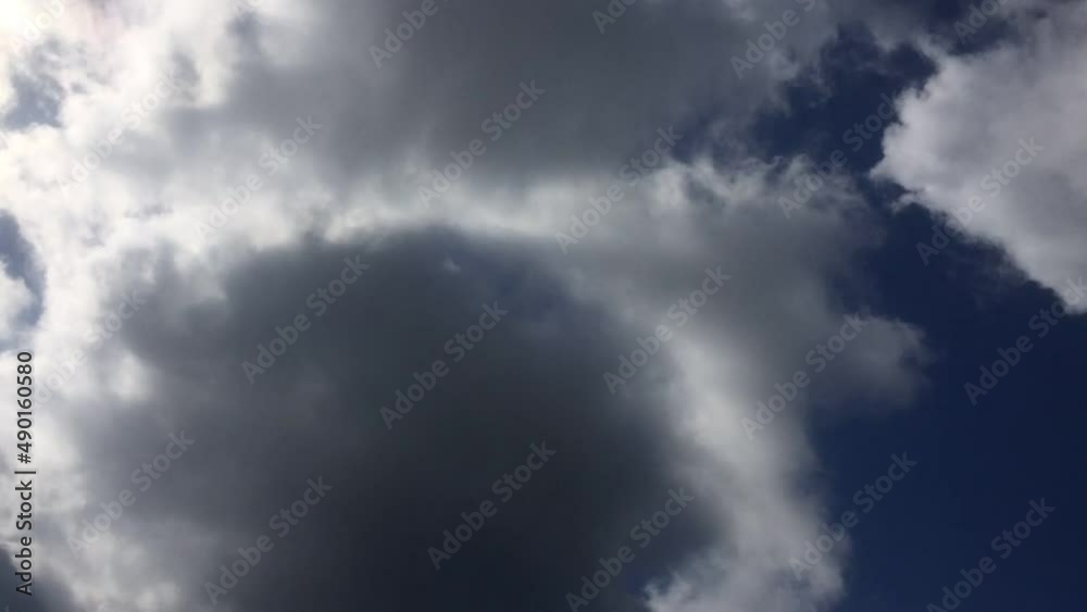 Clouds move quickly across the blue sky. Summer sunny day, the bright sun shines, under it white-gray clouds quickly fly by. They change their shape and size on the fly. Clouds move quickly across the blue sky. Summer sunny day, the bright sun shines, under it white-gray clouds quickly fly by. They change their shape and size on the fly.