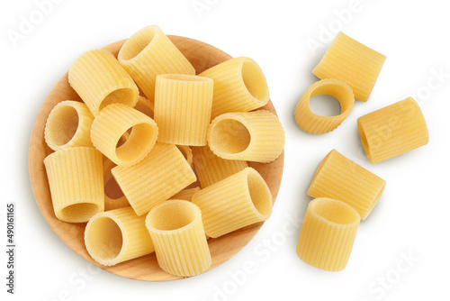 raw italian pasta in wooden bowl isolated on white background with clipping path . Mezze Maniche Rigate Bronze die. Top view. Flat lay