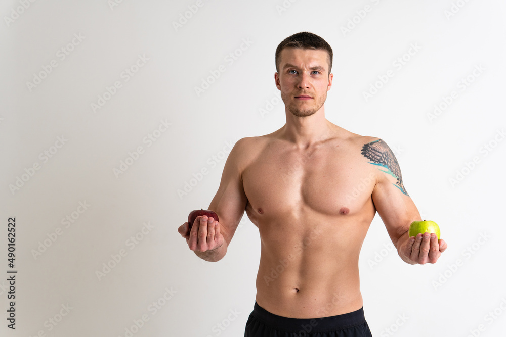 Man holds apples in fitness white background isolated man health, young model portrait, torso Hand energy nutrition, attractive chest