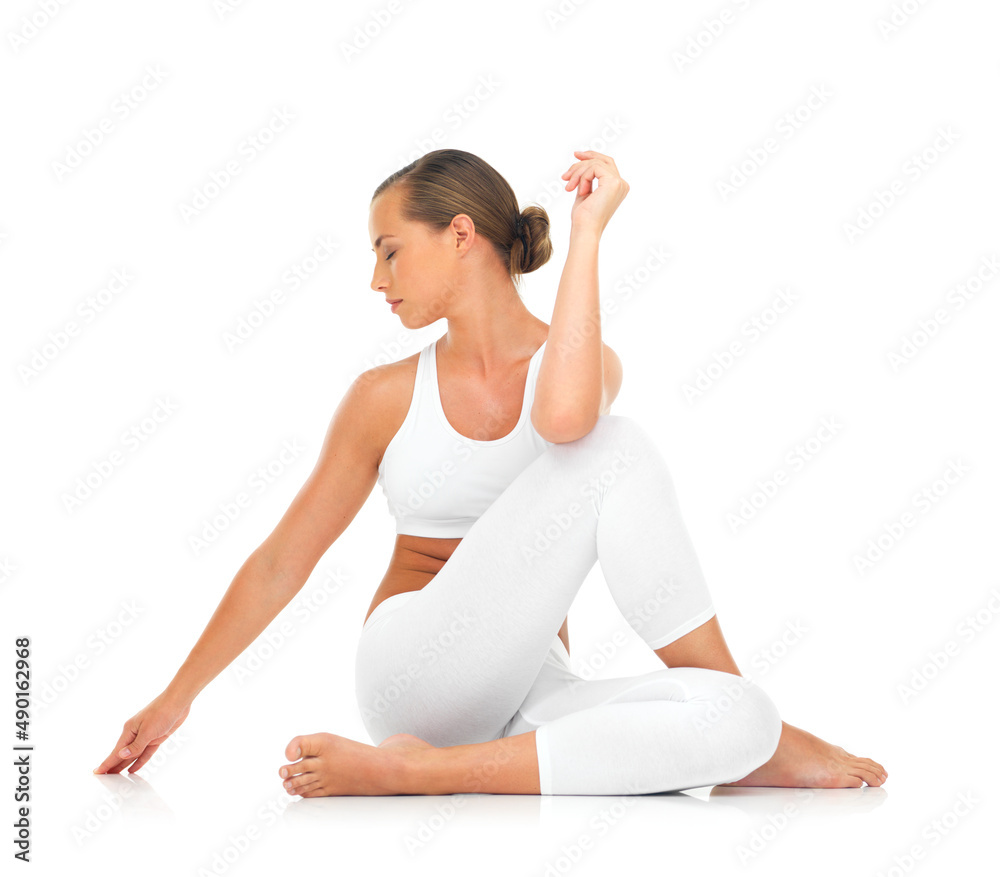 Limbering up for a workout. A sporty young woman stretching against a white background. Limbering up for a workout. A sporty young woman stretching against a white background.