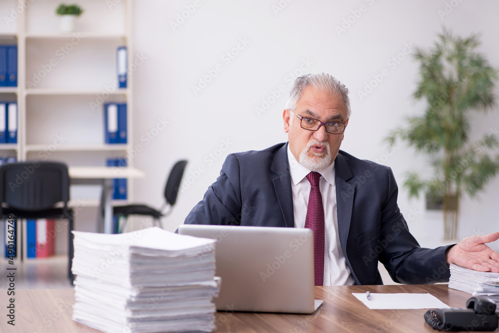 Old male employee and too much work in the office Old male employee and too much work in the office