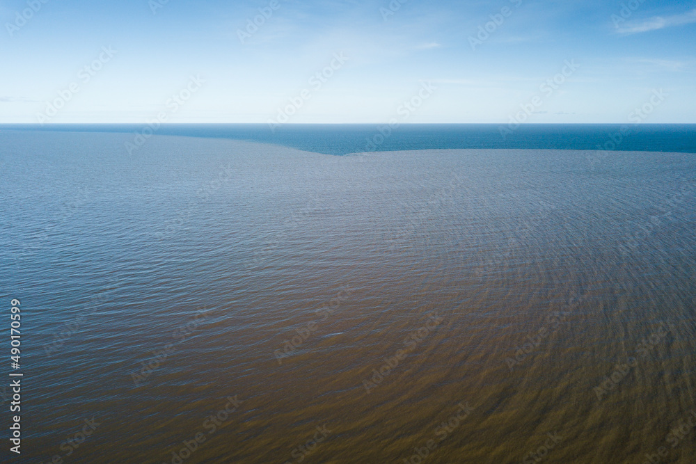 Obraz premium Aerial view of Baltic sea and dark, deep water in the distance in sunny spring day, Kolka, Latvia.