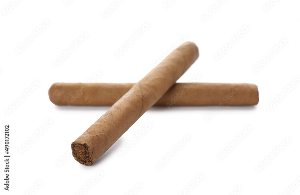 Cigars wrapped in tobacco leaves on white background Cigars wrapped in tobacco leaves on white background