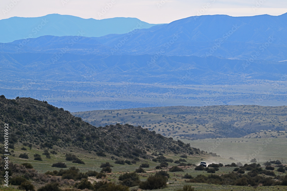 Off road vehicle traveling dirt road Carrizo Plain California.