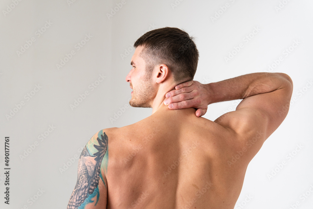 The muscles of the neck in a man on a white background are hurt back body injury, cramp spine white massage stress, hand holding. red care, ain suffer attractive The muscles of the neck in a man on a white background are hurt back body injury, cramp spine white massage stress, hand holding. red care, ain suffer attractive