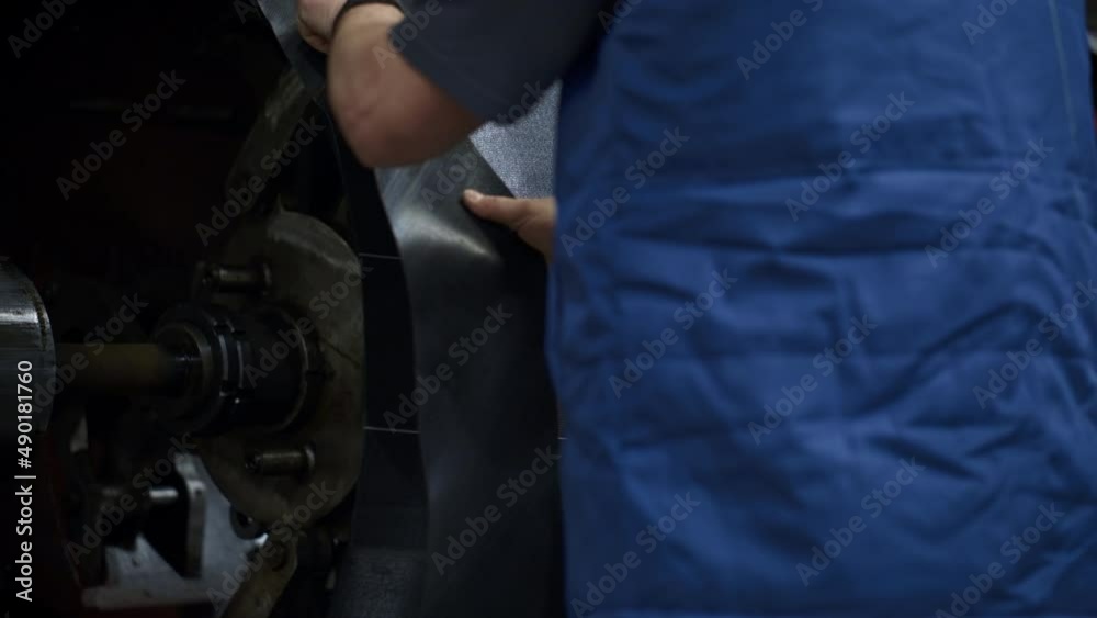 Worker hands tire production process operating in modern factory facility Worker hands tire production process operating in modern factory facility