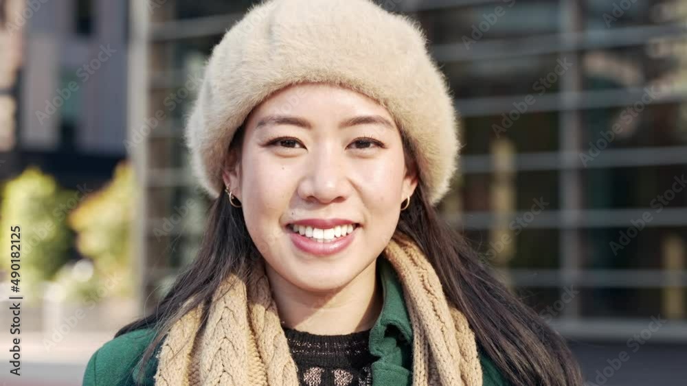 Young smiling asian woman in formal winter outfit looking to camera outside business workplace Young smiling asian woman in formal winter outfit looking to camera outside business workplace