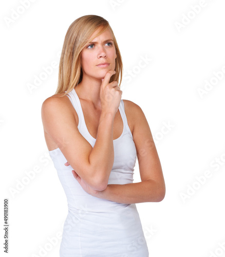 Deep in contemplation. A beautiful young woman considering her option on a white background.