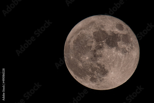 Closuep shot of the full moonon a black night sky photo