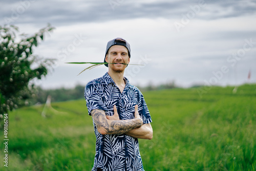 Beautiful view of a White man checking the oat field Bali photo