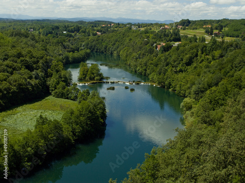 Landscape of The Mreznica surrounded by greenery on a sunny day in Karlovac County, Croatia photo