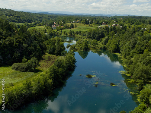 Landscape of The Mreznica surrounded by greenery on a sunny day in Karlovac County, Croatia photo