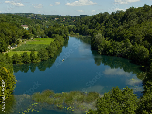 Landscape of The Mreznica surrounded by greenery on a sunny day in Karlovac County, Croatia photo