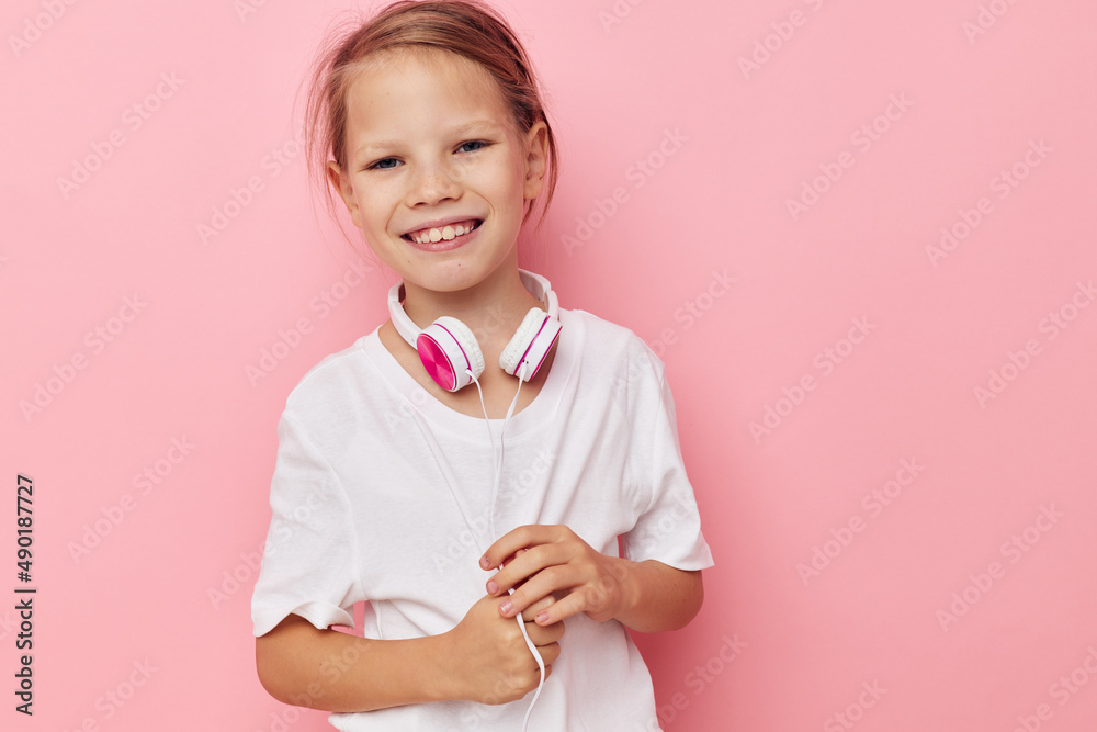 Portrait of happy smiling child girl smile posing headphones isolated background Portrait of happy smiling child girl smile posing headphones isolated background