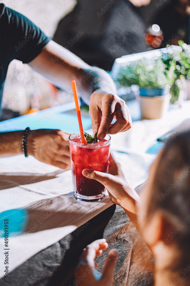 Φωτογραφία Vertical shot of a red drink with glasses in a girl's hand being finished with d