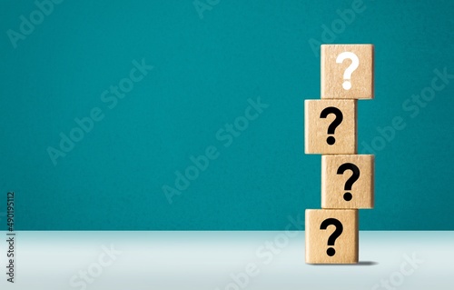 Wooden cube block with question mark mean what on table background photo