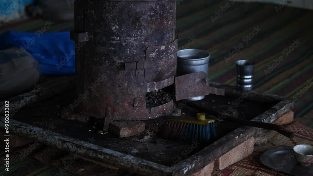 Person Walking Past Rusty Traditional Wood Burner On Floor. Slow Motion Person Walking Past Rusty Traditional Wood Burner On Floor. Slow Motion