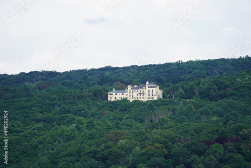 View of the Dick's Castle on the top of green forest trees in West Point, NY State photo