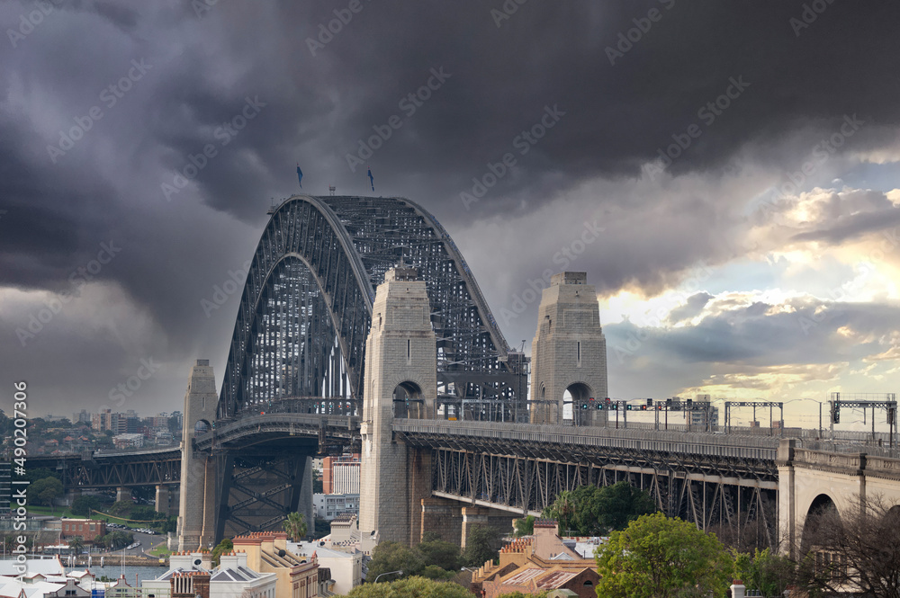 Naklejka premium Breathtaking view of Sydney Harbour Bridge against a dark clouds, Sydney, Australia