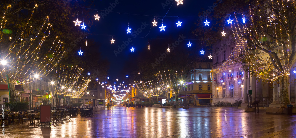 View on the New Year's illuminated streets of Avignon at evening, France