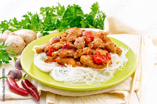 Stir-fry of chicken with peppers in plate on white board