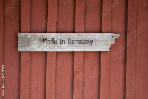 Closeup shot of a red wall with the writing of 