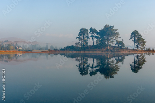 Landscape of Lock Tulla covered in the fog in the daylight in Scotland photo