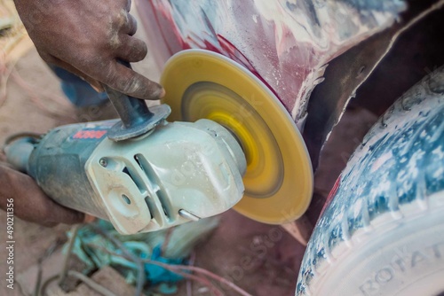 African Auto Bodyworks,  Welding a Car in Africa,  2 African men working on a car, African American auto mechanic at work, African American working with electrodes photo