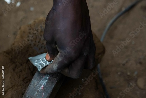 African Auto Bodyworks,  Welding a Car in Africa,  2 African men working on a car, African American auto mechanic at work, African American working with electrodes photo